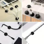 Multi-colored silicone adhesive cable management clips on a wooden desk.