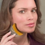 Crescent shaped ergonomic makeup brush for facial contouring and foundation.