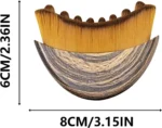 Crescent shaped ergonomic makeup brush for facial contouring and foundation.