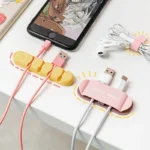 Cute animal face silicone adhesive multi-slot cable organizer and cord holder.