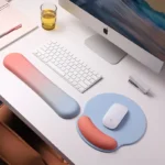 Ergonomic keyboard and mouse wrist rest set with pastel gradient colors.