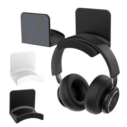 Black adhesive headphone hook holding over-ear headphones under desk