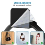 Black adhesive headphone hook holding over-ear headphones under desk