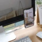 Clear acrylic monitor shelf with phone holder and desk organizer.