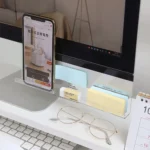 Clear acrylic monitor shelf with phone holder and desk organizer.