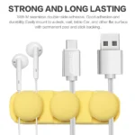 Adhesive silicone cable organizer for desk and wall management.