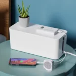 White smart cable management box, digital power monitor, charging phone.