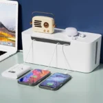White smart cable management box, digital power monitor, charging phone.