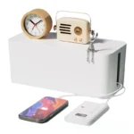 White smart cable management box, digital power monitor, charging phone.