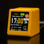 Smart WiFi desktop weather station and digital clock in yellow.