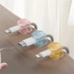 Self-adhesive translucent pastel cable clips for desk organization.