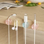 Self-adhesive translucent pastel cable clips for desk organization.