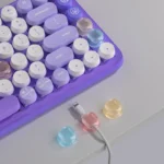 Self-adhesive translucent pastel cable clips for desk organization.