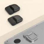 Ultra-thin foldable adhesive laptop stand elevating a silver laptop