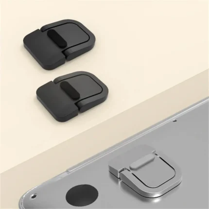Ultra-thin foldable adhesive laptop stand elevating a silver laptop