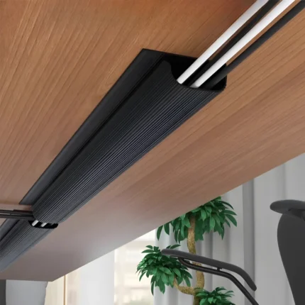 Under-desk cable management channel with self-adhesive backing.