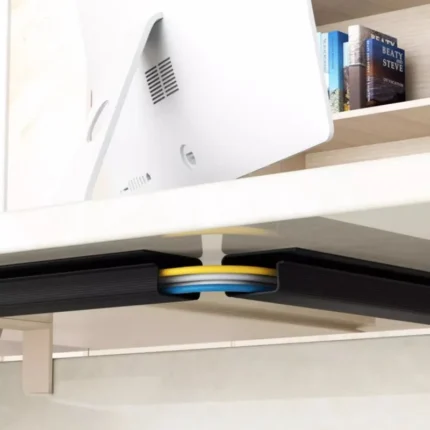 Under-desk cable management channel with self-adhesive backing.