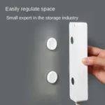 Magnetic adhesive wall mount holding a remote control and cable