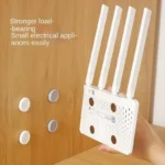 Magnetic adhesive wall mount holding a remote control and cable