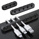 Adhesive desk cable organizer clips holding multiple data and charging cables