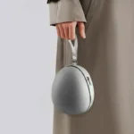 Compact egg-shaped hard shell travel case for foldable items