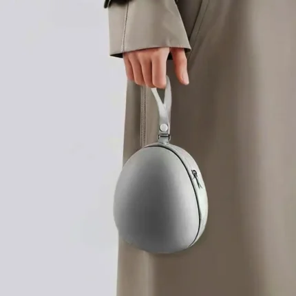 Compact egg-shaped hard shell travel case for foldable items