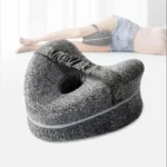 Contoured knee pillow for side sleepers with strap for leg support