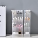 Frosted clear multi-compartment desk organizer with pens and makeup brushes