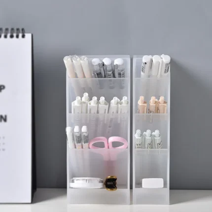 Frosted clear multi-compartment desk organizer with pens and makeup brushes