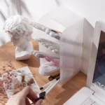 Frosted clear multi-compartment desk organizer with pens and makeup brushes