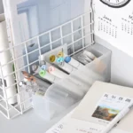 Frosted clear multi-compartment desk organizer with pens and makeup brushes