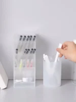 Frosted clear multi-compartment desk organizer with pens and makeup brushes