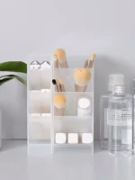 Frosted clear multi-compartment desk organizer with pens and makeup brushes