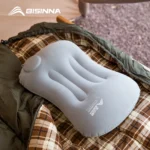 Grey inflatable camping pillow with built-in press pump