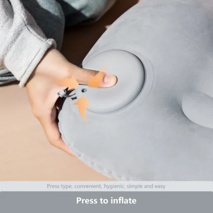 Grey inflatable camping pillow with built-in press pump