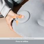 Grey inflatable camping pillow on sleeping bag in tent