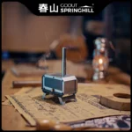 Miniature ambiance stove burning incense on a rustic table.