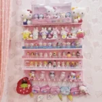 Pink pegboard wall organizer with shelves for cute collectibles.