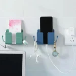 Self-adhesive wall phone holder with charging slot and side hooks