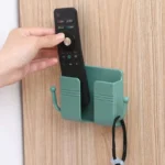 Self-adhesive wall phone holder with charging slot and side hooks