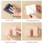 Self-adhesive wall phone holder with charging slot and side hooks