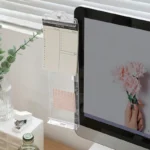 Clear monitor side organizer holding notes and smartphone