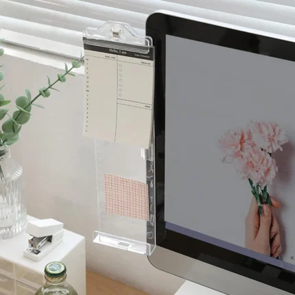 Clear monitor side organizer holding notes and smartphone