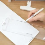 Clear monitor side organizer holding notes and smartphone