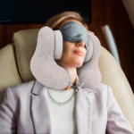 U-shaped travel neck pillow with integrated headphones and adjustable strap.