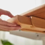 Under desk slide-out wood drawer with adhesive installation.