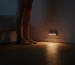 Motion sensor night light casting warm floor glow.