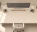 Minimalist desk setup showing properly positioned desktop speakers at ear level with correct toe-in angle